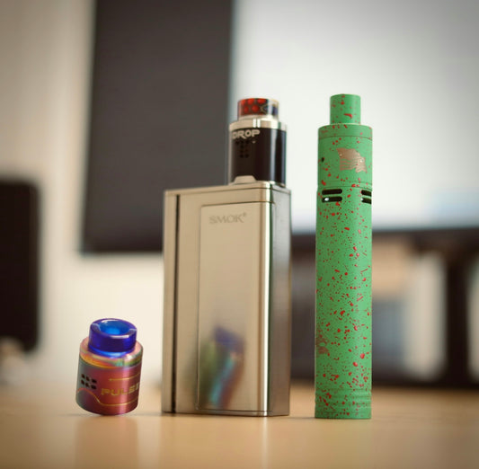 a green and white tube next to a white and black tube with a green tube and a blue